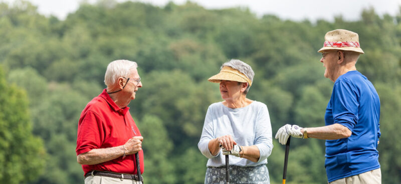 Three seniors meet at the golf course